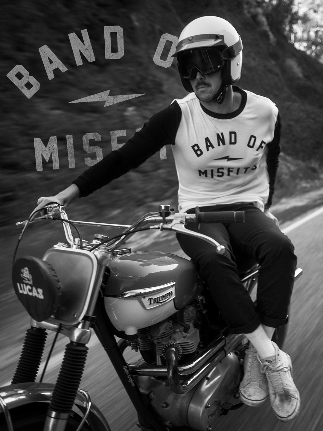 Person sitting on a motorcycle with 'Band of Misfits' branding in the background